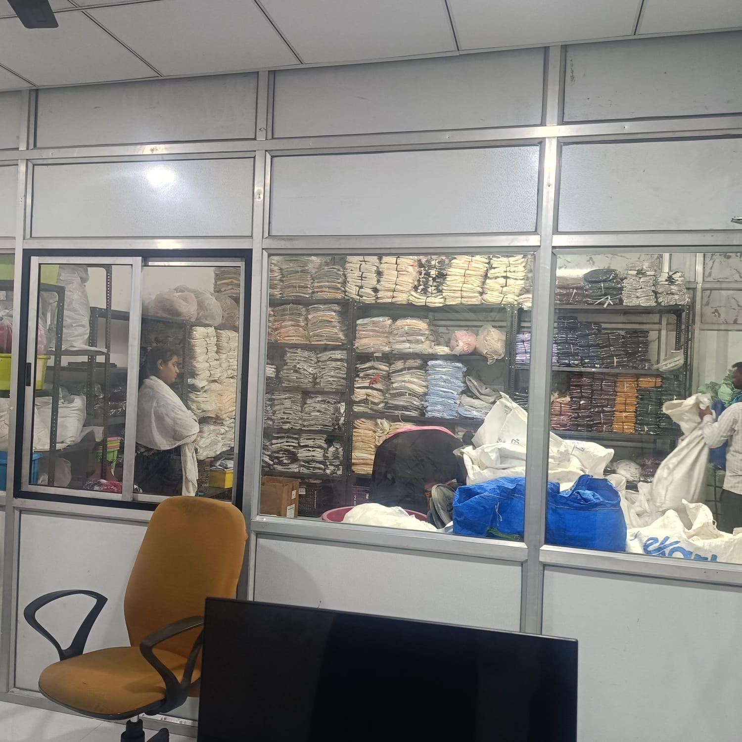 Team members sorting stock and packing an order at J B International